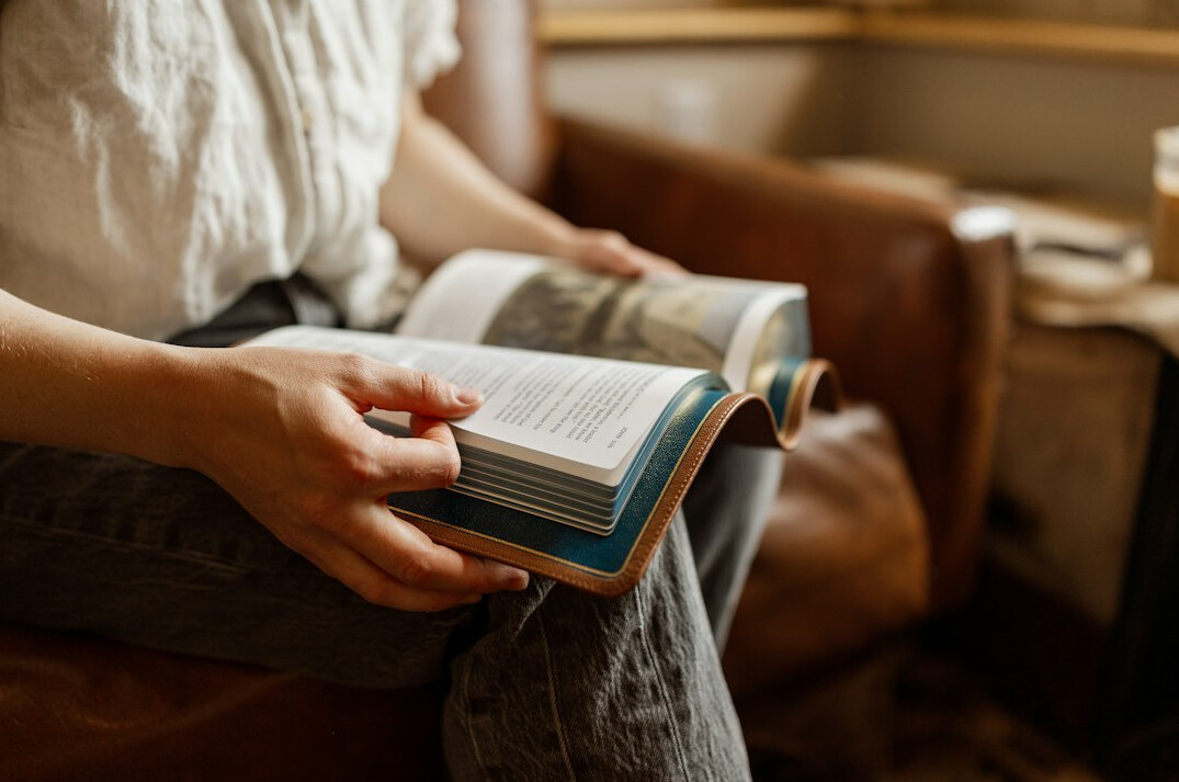 Brazilian woman writing thoughtfully at a home desk
